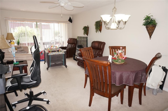 dining space with light colored carpet and ceiling fan with notable chandelier