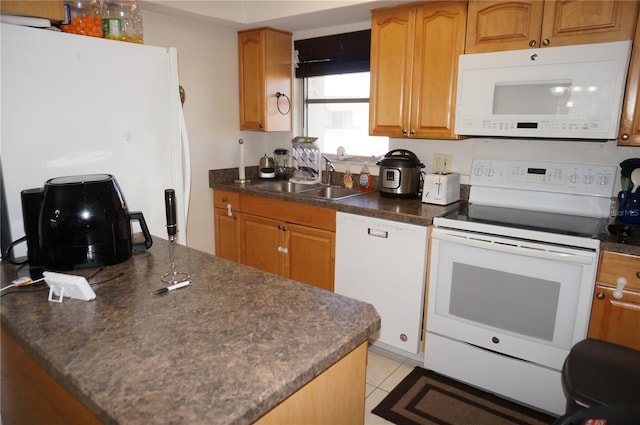 kitchen featuring sink, white appliances, and light tile patterned flooring