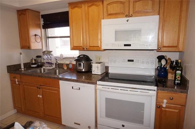 kitchen with sink, white appliances, and light tile patterned floors