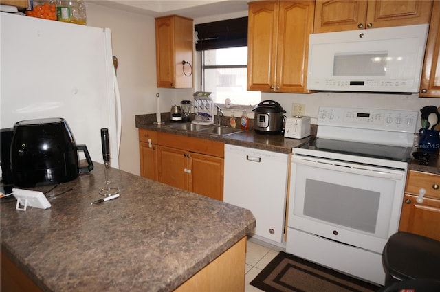 kitchen featuring sink, white appliances, and light tile patterned floors