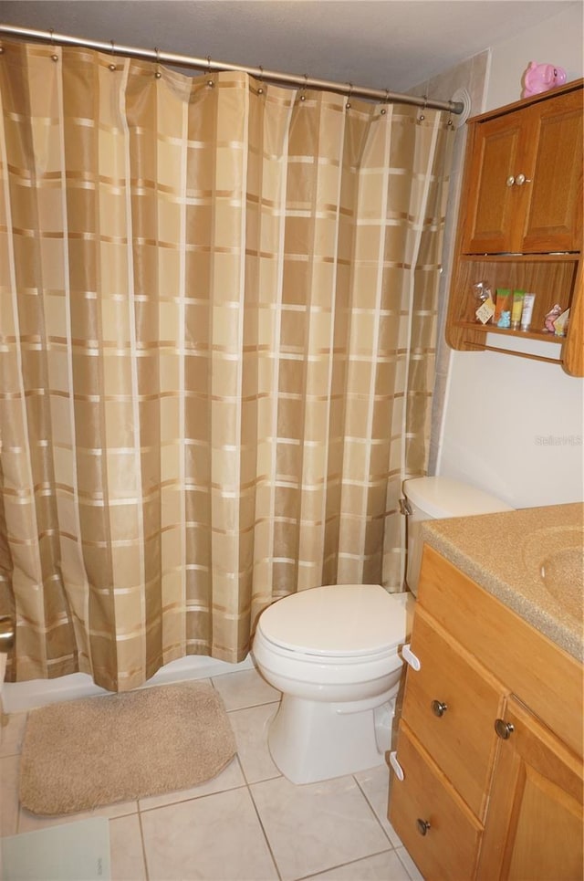 bathroom with vanity, tile patterned floors, and toilet