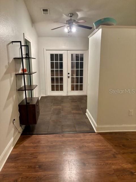 hall featuring dark wood-type flooring and french doors