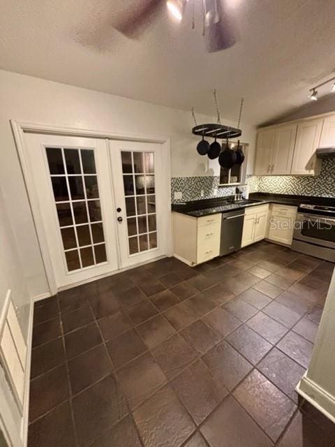 kitchen featuring french doors, backsplash, ceiling fan, stainless steel appliances, and white cabinets