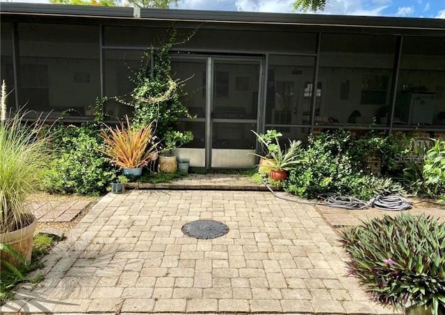 view of patio / terrace featuring a sunroom