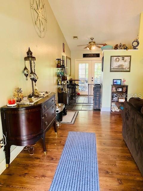 18085 Wintergarden Ave, Port Charlotte, FL 33948 - foyer with a ceiling fan, wood finished floors, french doors, and lofted ceiling