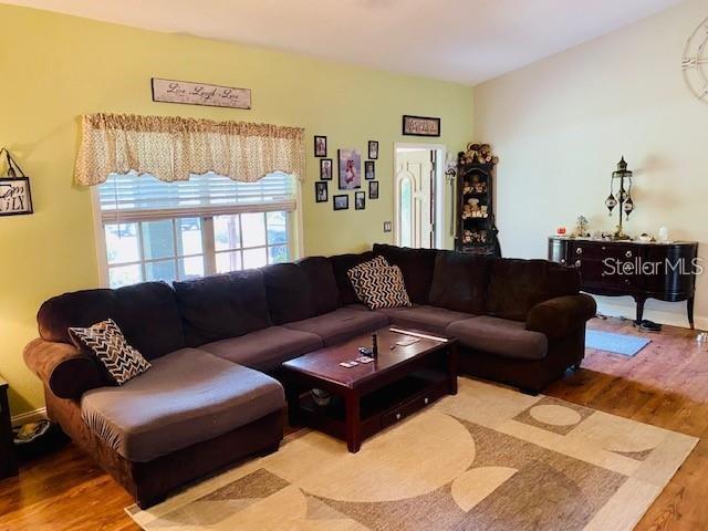 18085 Wintergarden Ave, Port Charlotte, FL 33948 - living area with wood finished floors