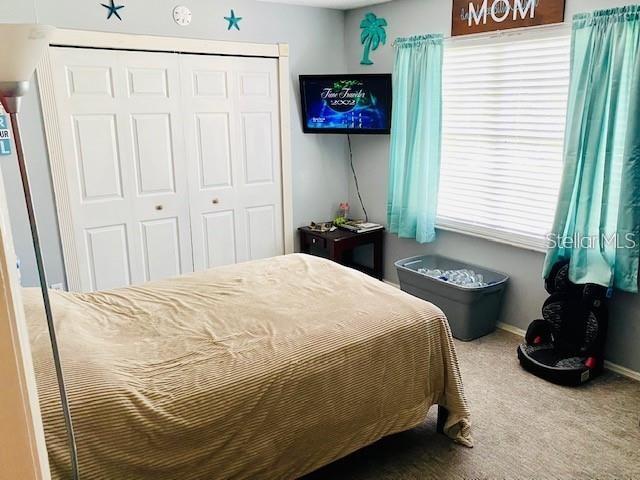 18085 Wintergarden Ave, Port Charlotte, FL 33948 - carpeted bedroom featuring a closet