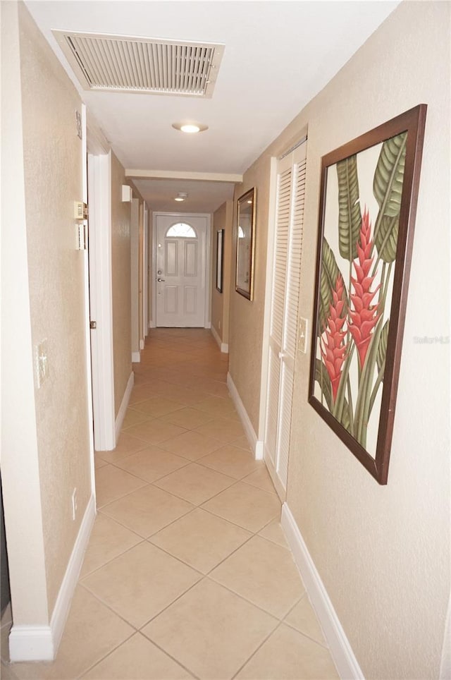 corridor featuring light tile patterned floors