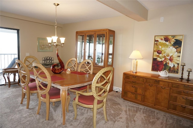 carpeted dining area with beam ceiling, a baseboard heating unit, and a chandelier