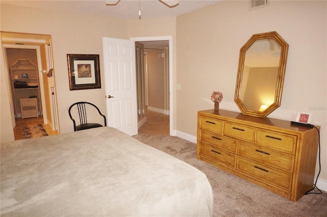 bedroom featuring light carpet and ceiling fan