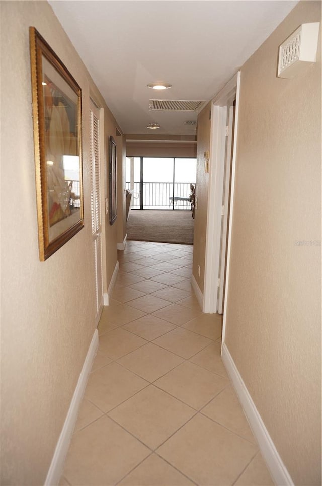 corridor featuring light tile patterned flooring