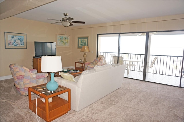 carpeted living room with ceiling fan