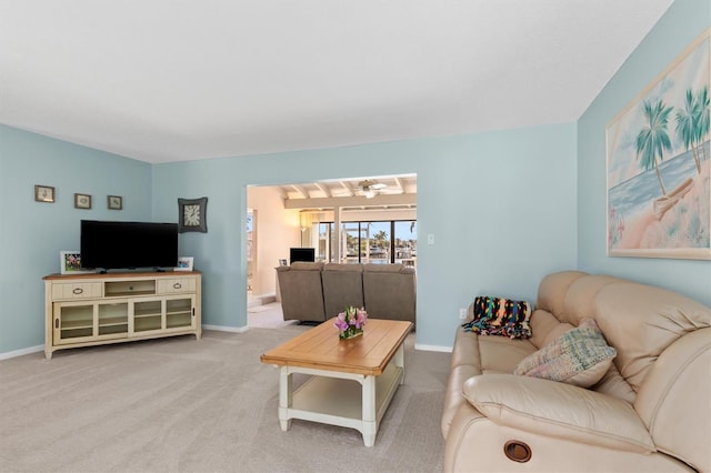 carpeted living room featuring ceiling fan