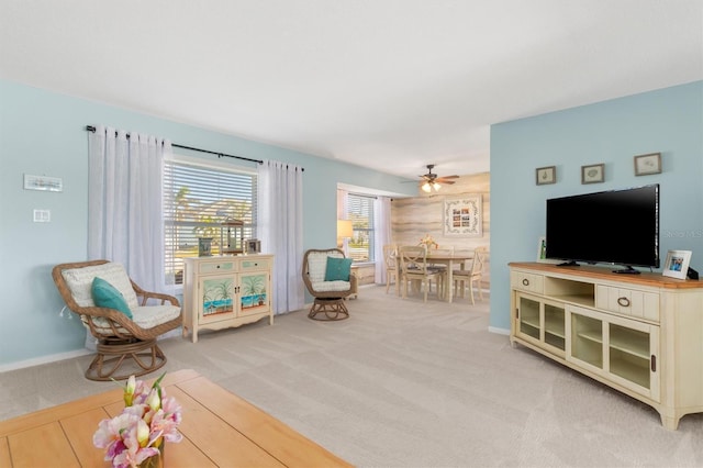 sitting room featuring light carpet and ceiling fan