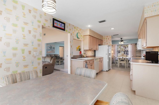 dining room featuring sink and ceiling fan