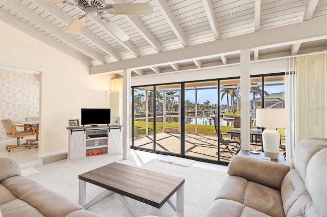 living room featuring lofted ceiling with beams, light colored carpet, and ceiling fan