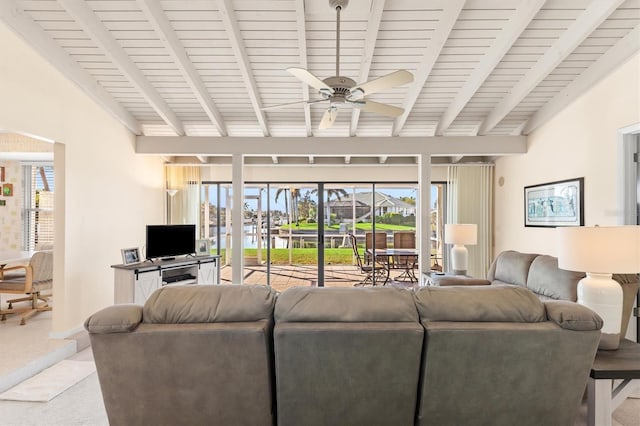 living room with beamed ceiling, carpet flooring, and ceiling fan