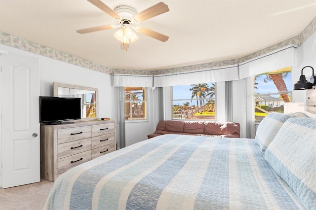 bedroom featuring ceiling fan and light colored carpet