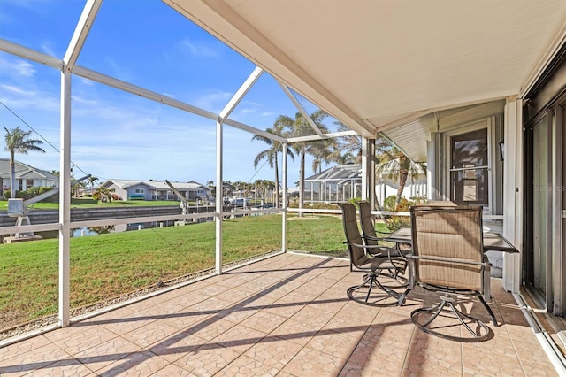 unfurnished sunroom with a water view