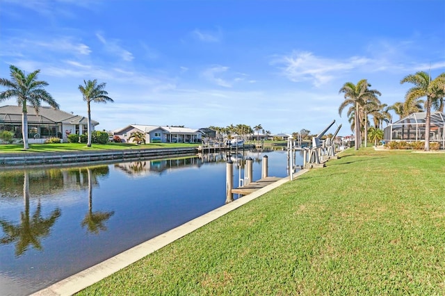 dock area featuring a water view and a lawn