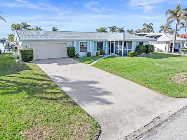 single story home featuring a garage and a front yard