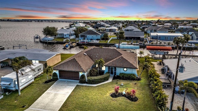 aerial view at dusk with a water view