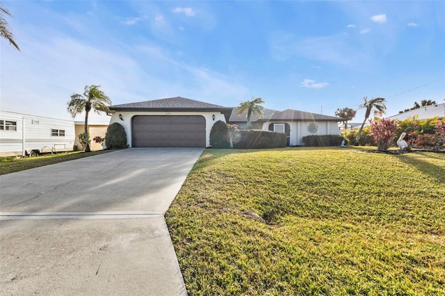 single story home with a garage and a front lawn