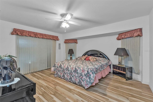 bedroom featuring hardwood / wood-style floors and ceiling fan