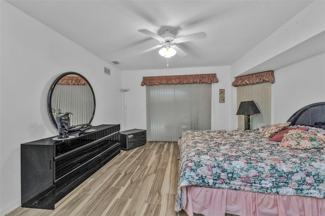 bedroom with ceiling fan and light wood-type flooring