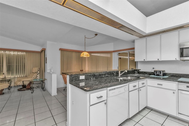 kitchen with sink, light tile patterned floors, white dishwasher, white cabinets, and decorative light fixtures