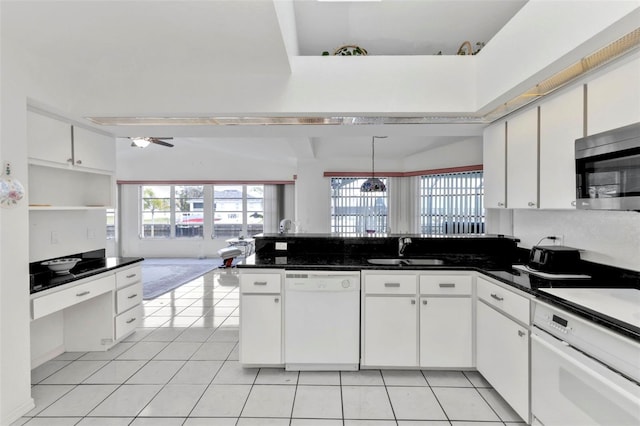 kitchen featuring light tile patterned flooring, white cabinetry, sink, hanging light fixtures, and white appliances