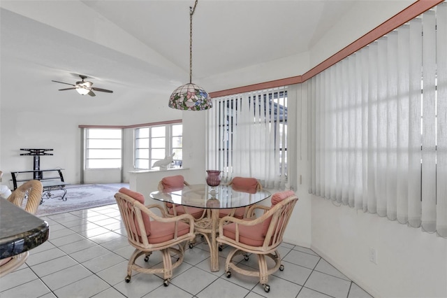 dining space featuring light tile patterned flooring, vaulted ceiling, and ceiling fan