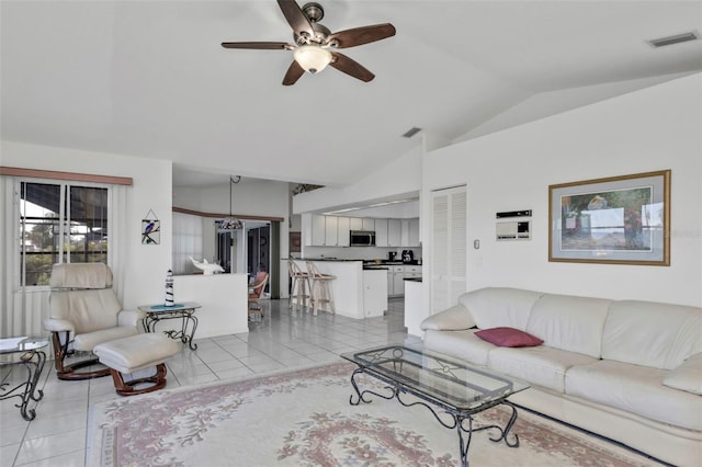 tiled living room featuring lofted ceiling and ceiling fan