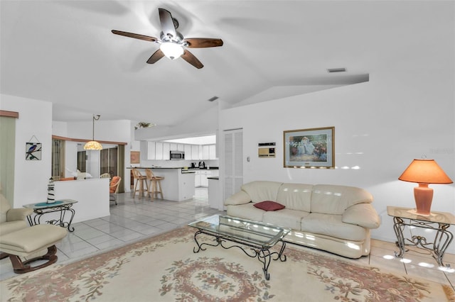 living room with ceiling fan, vaulted ceiling, and light tile patterned floors