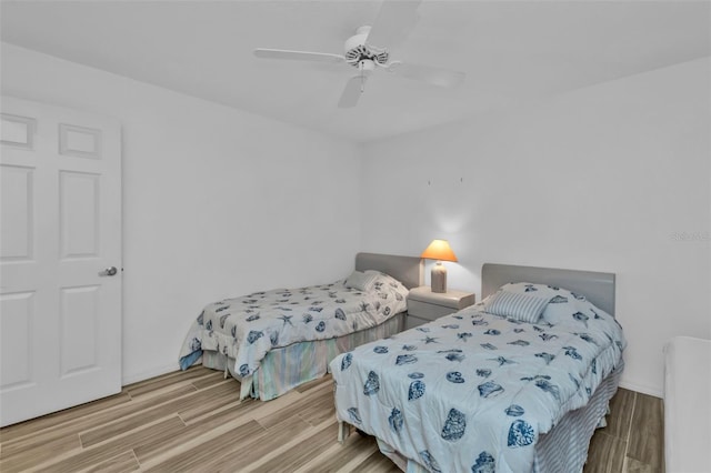 bedroom with ceiling fan and light hardwood / wood-style flooring