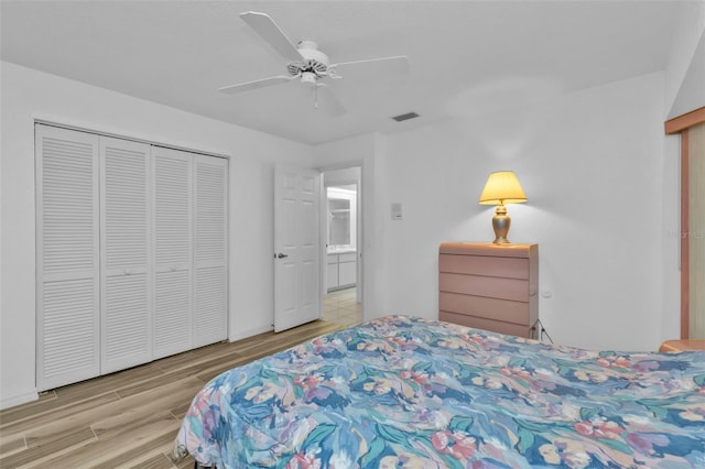 bedroom with light hardwood / wood-style floors, a closet, and ceiling fan