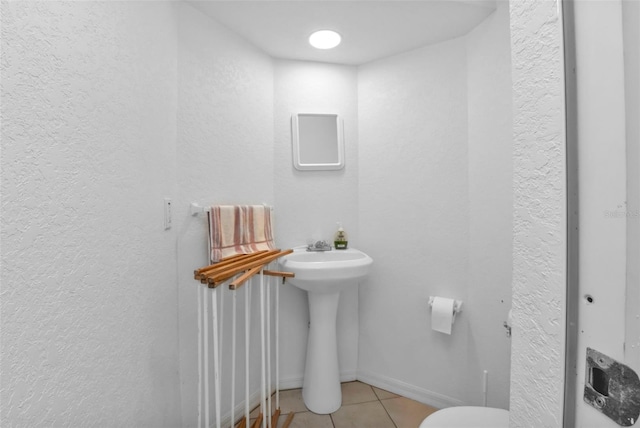 bathroom with tile patterned floors