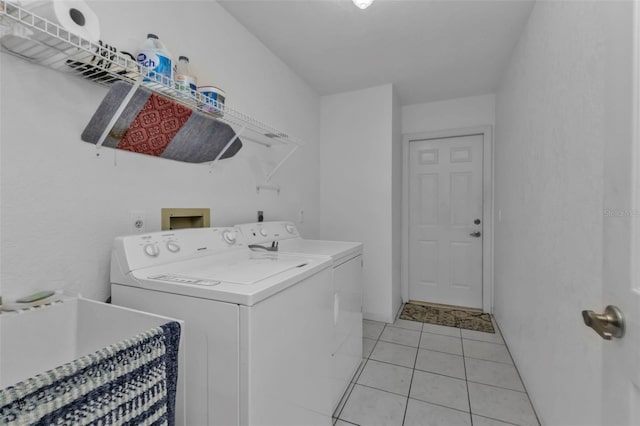 laundry room featuring separate washer and dryer, sink, and light tile patterned flooring