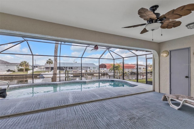 view of pool featuring a lanai, a patio area, and a water view