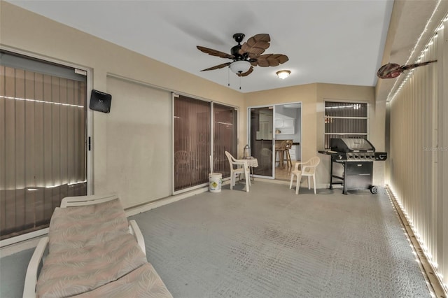 interior space with ceiling fan and a grill