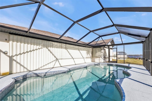 view of swimming pool with a patio and glass enclosure