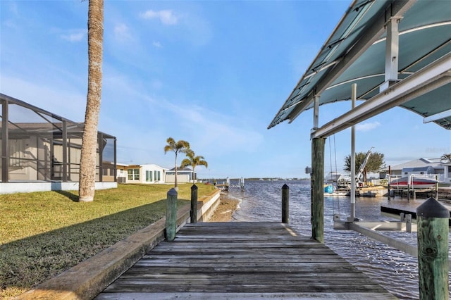 view of dock with a lanai, a yard, and a water view