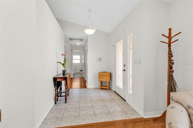 foyer entrance with light tile patterned flooring