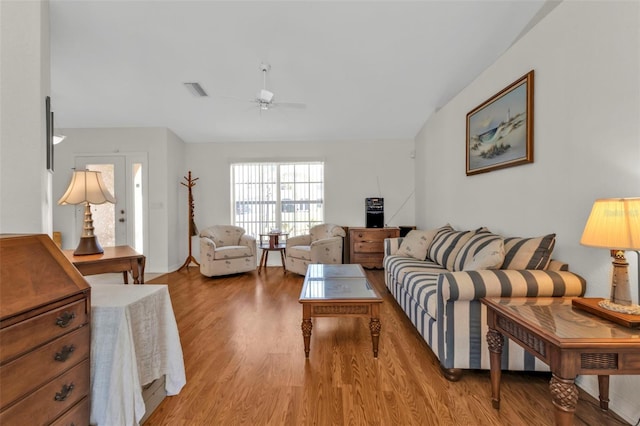 living room with light hardwood / wood-style floors and ceiling fan