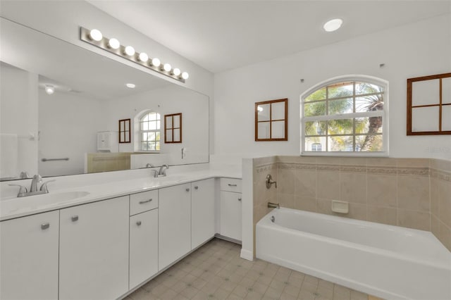 bathroom featuring vanity and a bath