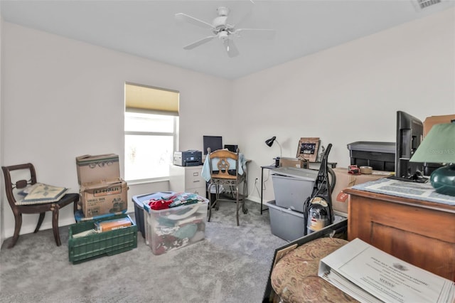 carpeted office space with ceiling fan