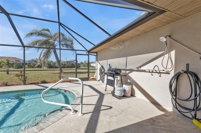 view of swimming pool featuring a lanai and a patio