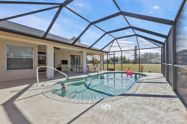 view of swimming pool featuring a patio, ceiling fan, and glass enclosure