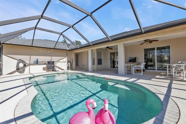 view of pool featuring a lanai, ceiling fan, and a patio area