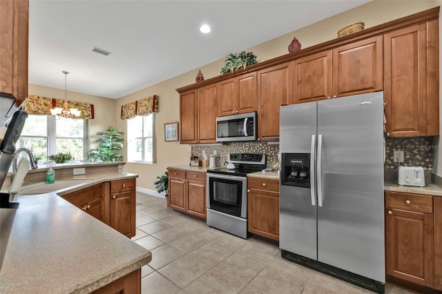 kitchen featuring stainless steel appliances, sink, decorative backsplash, and light tile patterned floors